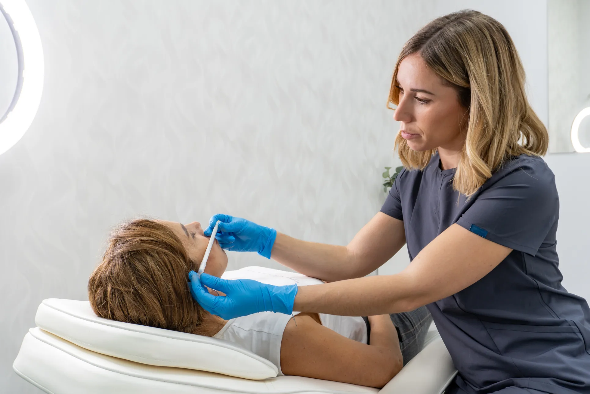 Woman receiving dermal filler injection for facial rejuvenation